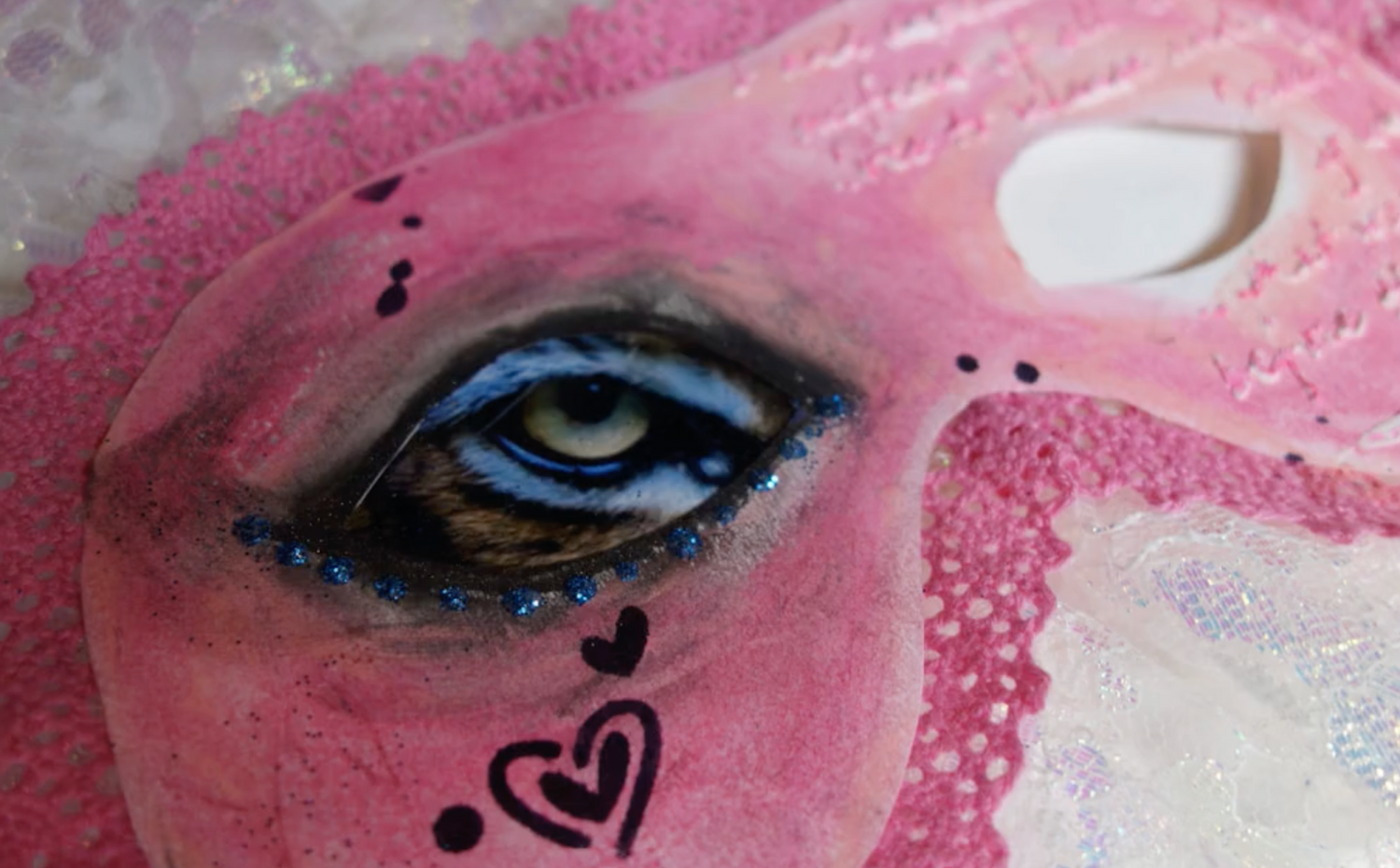 Abstract art image of a pink eye mask with one eye painted. This image was created by a student of art therapy now for the course how to use art therapy with others.